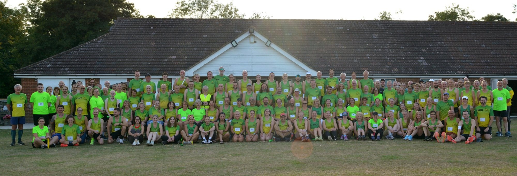 Well over a hundred Bishop’s Stortford Running Club members in green and gold outside the clubhouse, 2025