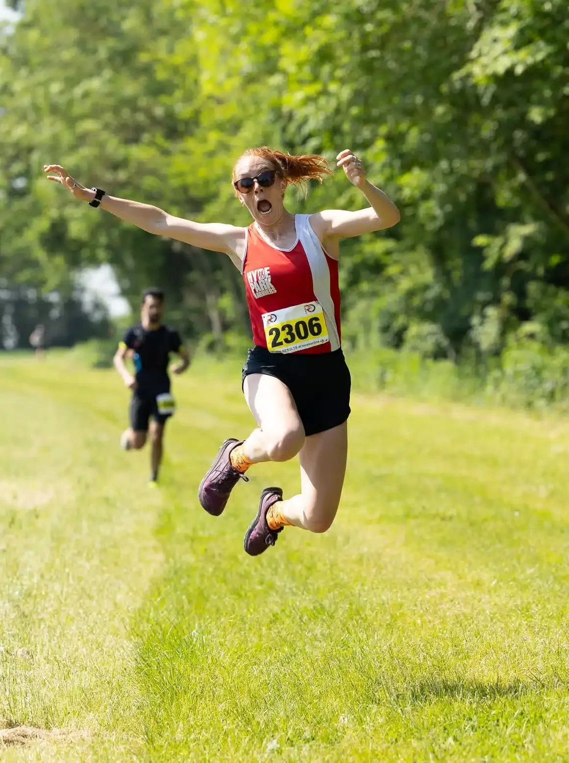 A Stort10 runner leaping for joy on the trail